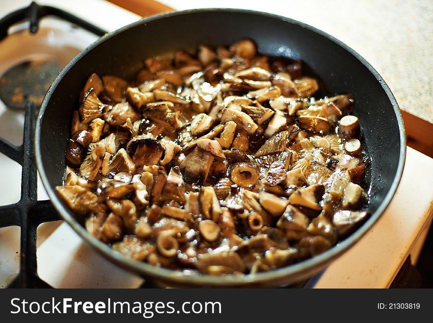 Grilled black mushrooms in skillet on oven