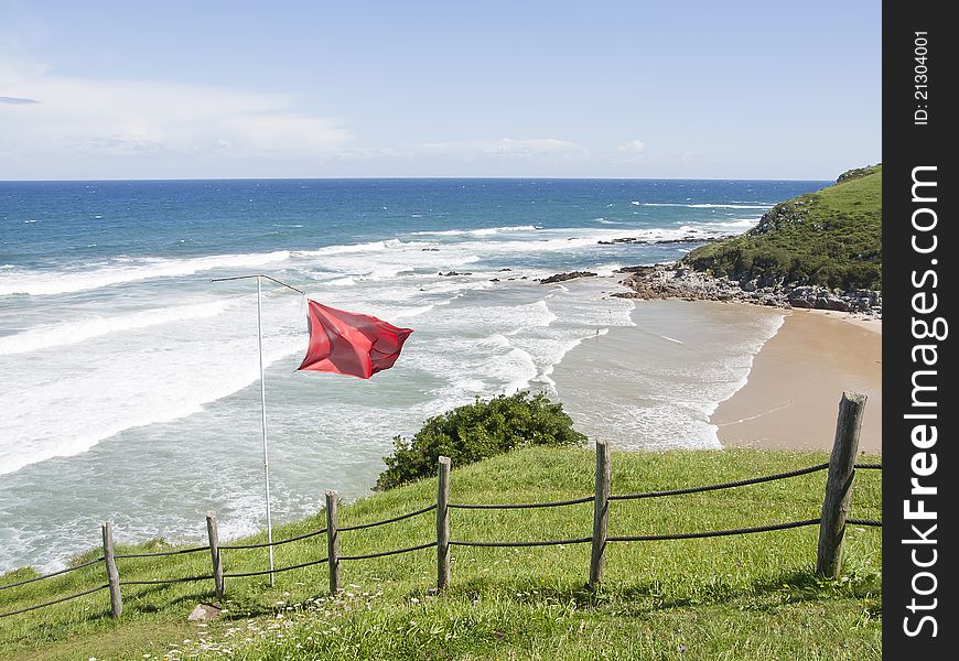 Red flag on the beach in asturias, Spain