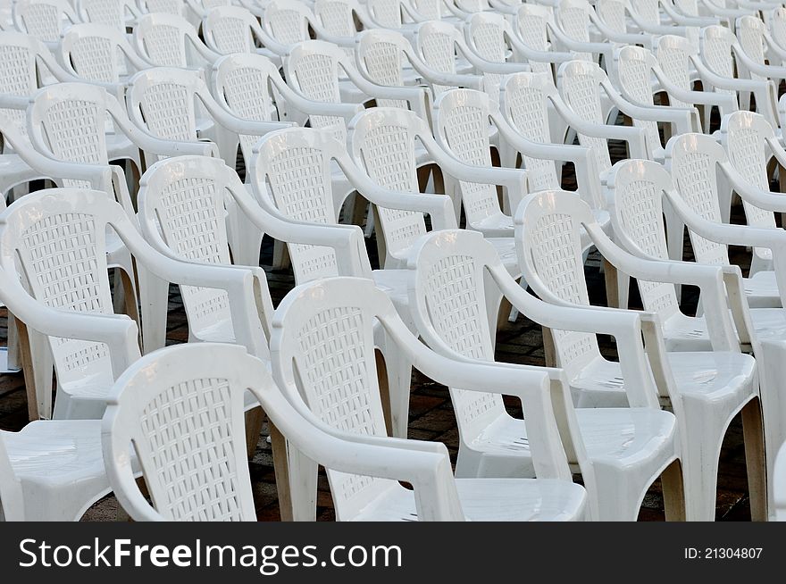 White plastic empty chairs in an open air cinema or theatre. White plastic empty chairs in an open air cinema or theatre