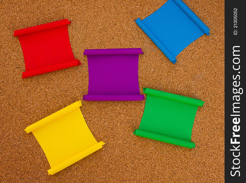 Collection of colorful note papers on cork board