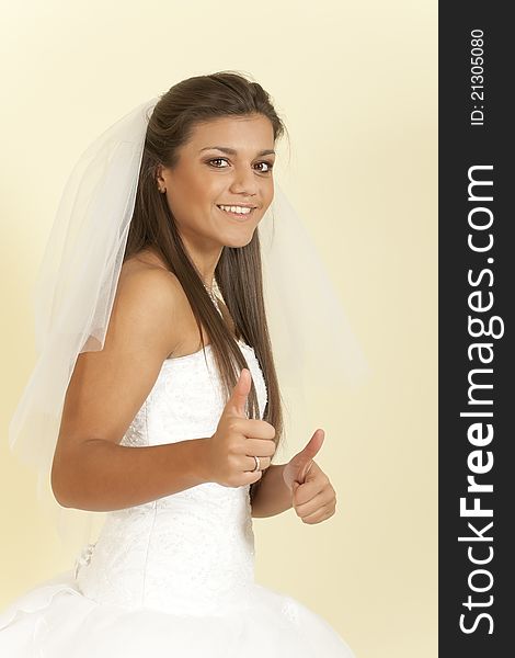 Brunette girl in a wedding dress shows that everything is fine