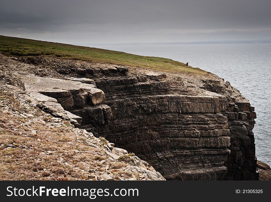 Cliffs by the sea under cloudy sky, Loop Head, Co. Clare, Ireland. Cliffs by the sea under cloudy sky, Loop Head, Co. Clare, Ireland