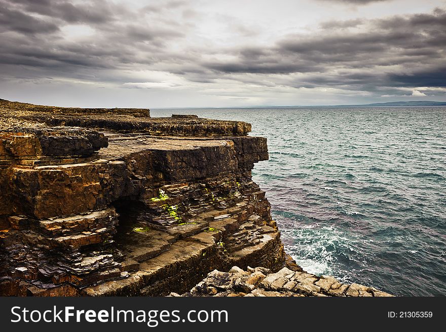 Cliffs by the sea under cloudy sky, Loop Head, Co. Clare, Ireland. Cliffs by the sea under cloudy sky, Loop Head, Co. Clare, Ireland