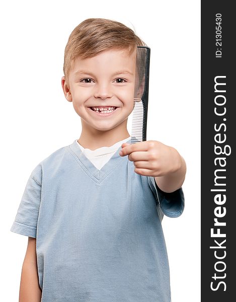 Portrait of a little boy holding a comb over white background. Portrait of a little boy holding a comb over white background