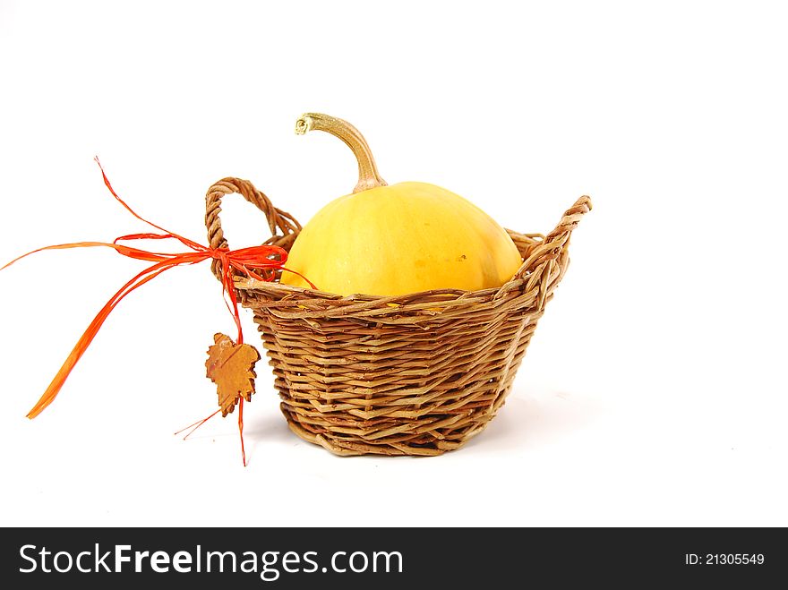 Pumkin in a rustic basket with orange ribbon and wood leaf. Pumkin in a rustic basket with orange ribbon and wood leaf