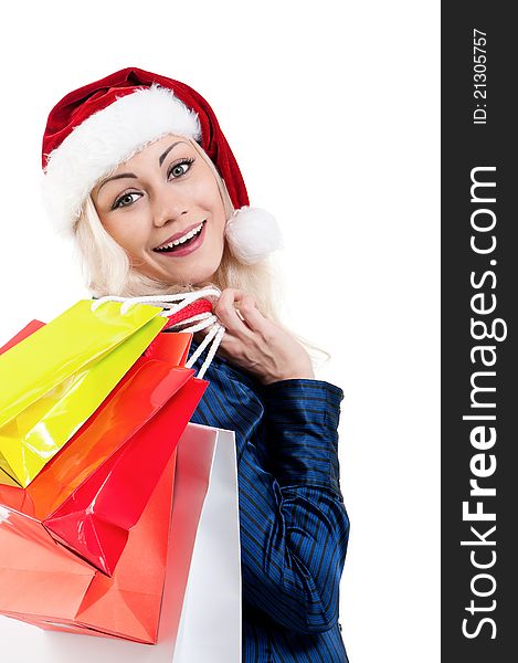 Portrait of a Christmas woman in santa hat holding a shopping bags over white background. Portrait of a Christmas woman in santa hat holding a shopping bags over white background