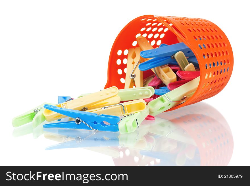 Pile of clothes-pegs of different colors on a white background. Pile of clothes-pegs of different colors on a white background