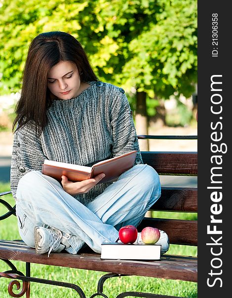 Portrait of a young female student with books at the campus