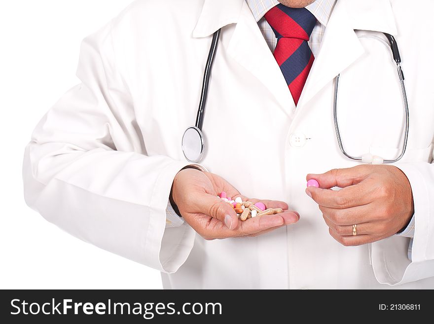 Young doctor holding a lot of colorful pills