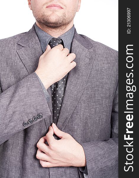 Businessman fixing his tie with both hands