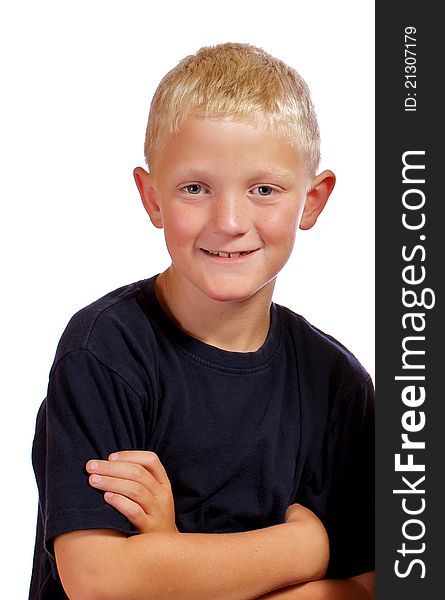 Boy with arms crossed smiling and posing for the camera. Boy with arms crossed smiling and posing for the camera