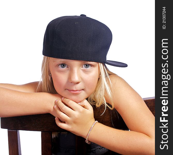 Young girl leaning on a chair with a smirk on her face. Young girl leaning on a chair with a smirk on her face