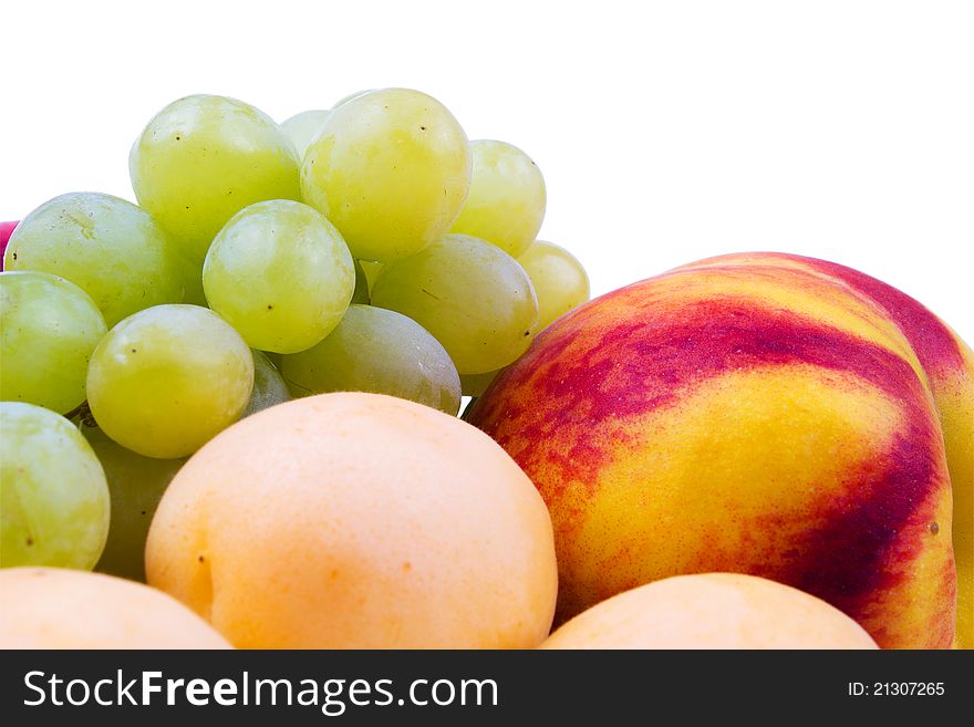 Grapes, peaches and apricots on a white background. Grapes, peaches and apricots on a white background