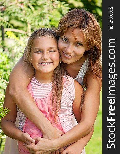 Happy mother with her daughter in park outdoors. Happy mother with her daughter in park outdoors