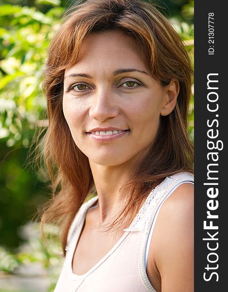 Close up portrait of beautiful caucasian woman in park. Close up portrait of beautiful caucasian woman in park