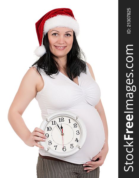Portrait of a pregnant woman in santa hat with clock over white background. Third trimester. Portrait of a pregnant woman in santa hat with clock over white background. Third trimester.