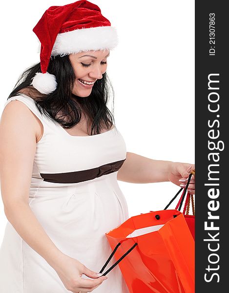 Portrait of a pregnant woman in santa hat holding a shopping bags over white background. Portrait of a pregnant woman in santa hat holding a shopping bags over white background