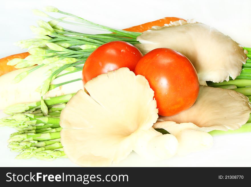 Variety of raw vegetables on white. Variety of raw vegetables on white