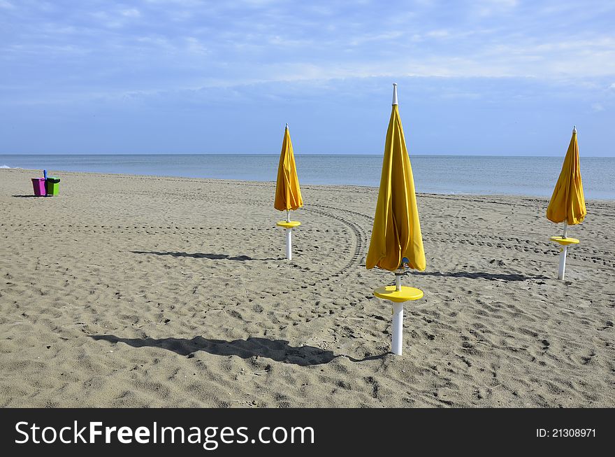 Yellow umbrellas on the beach in Civitanova - Italy. Yellow umbrellas on the beach in Civitanova - Italy