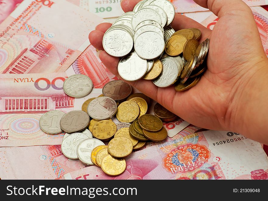 China's yuan, and a pile of coins, for financial material. China's yuan, and a pile of coins, for financial material