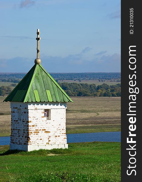 Lonely chapel on green grass