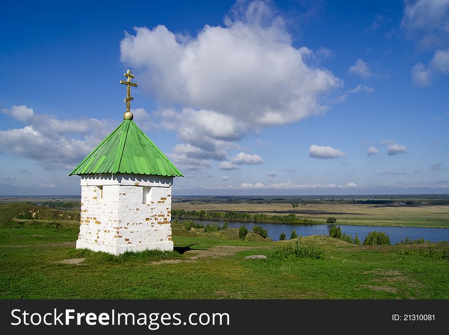 Lonely chapel on green grass