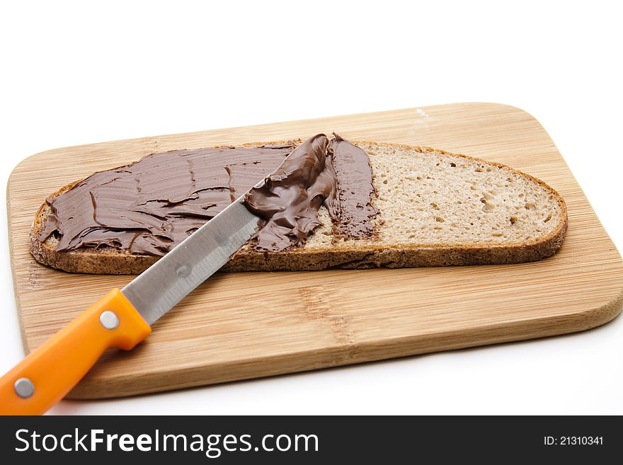 Bread with chocolate cream on cutting edge board