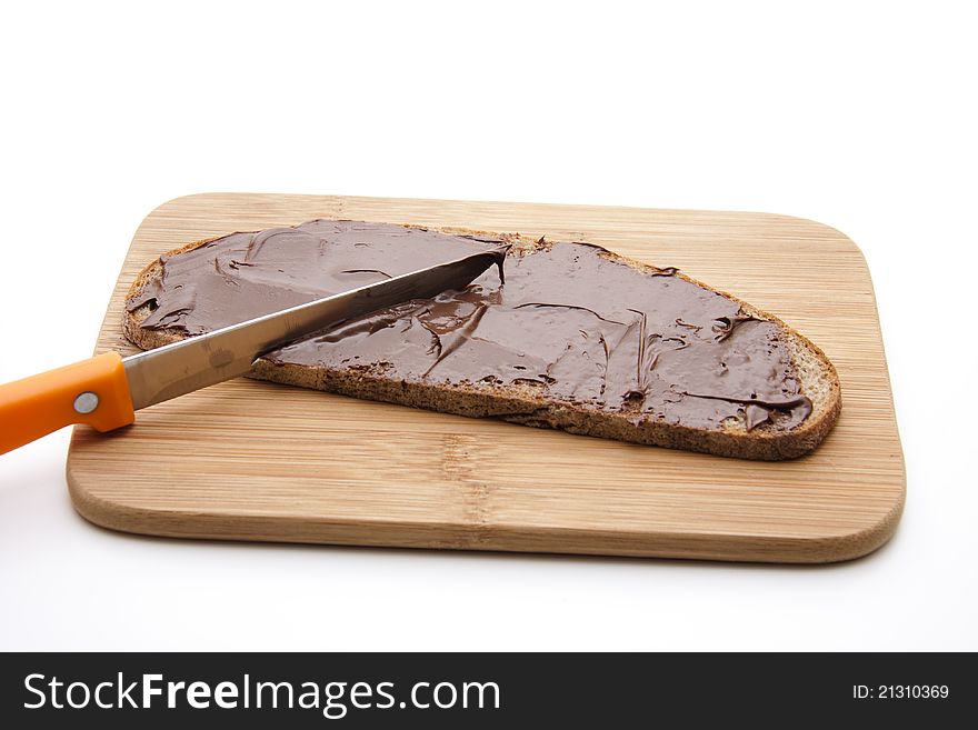 Bread with chocolate cream on cutting edge board