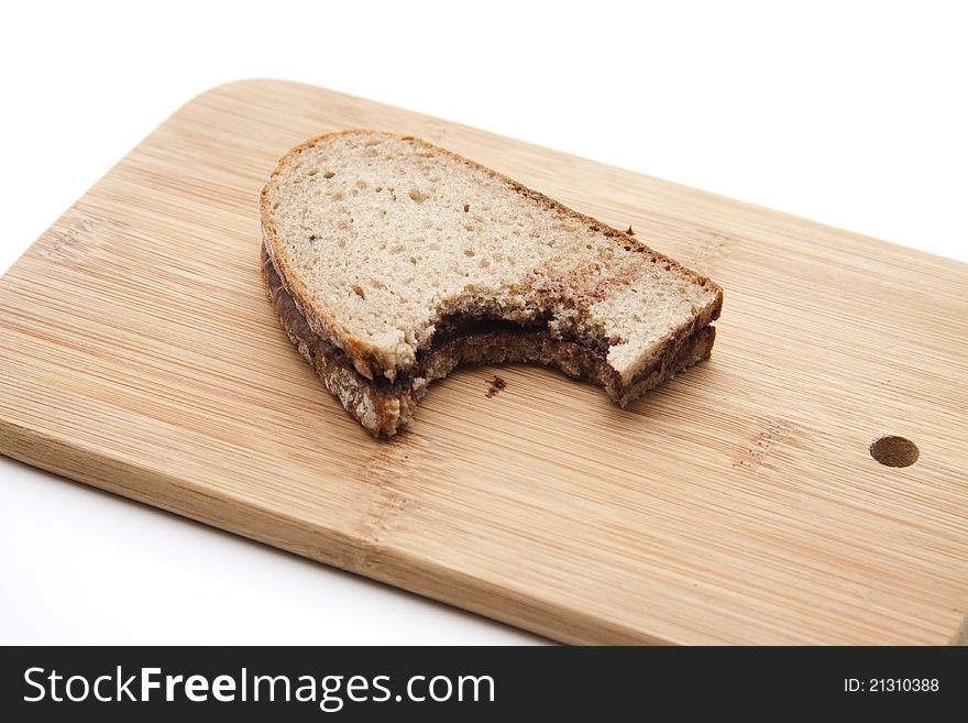 Bread with chocolate cream on cutting edge board