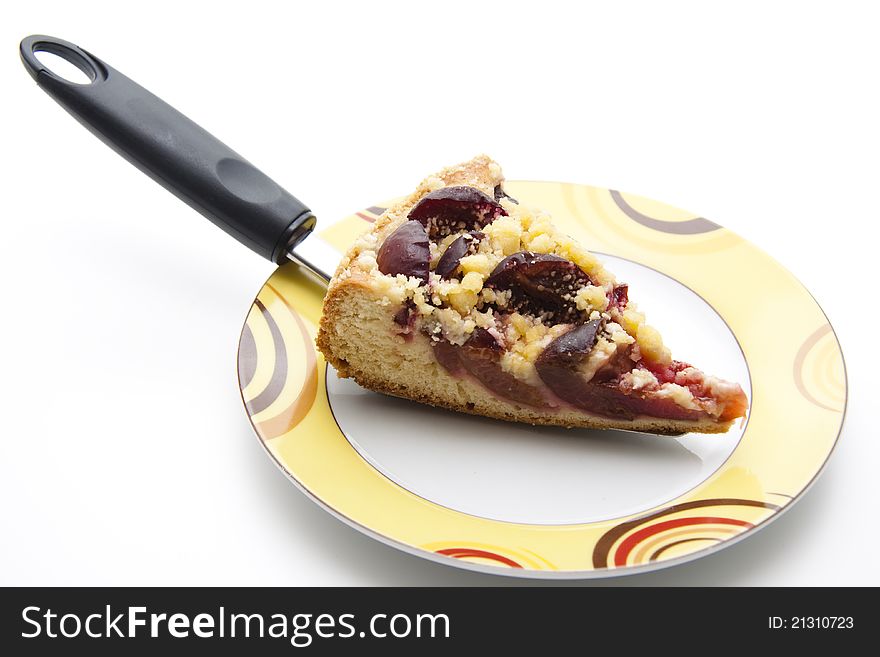 Plums cake on cake server and on plate