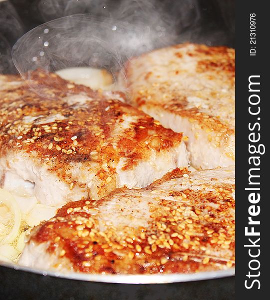 Natural pork chops in the pan with the onions