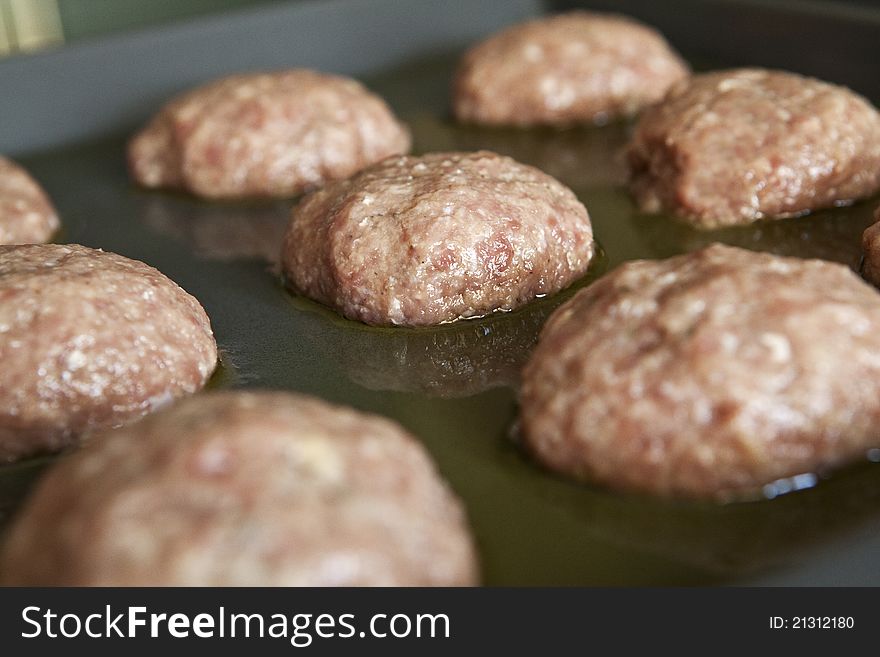 Raw meatballs on a pan, ready for grill