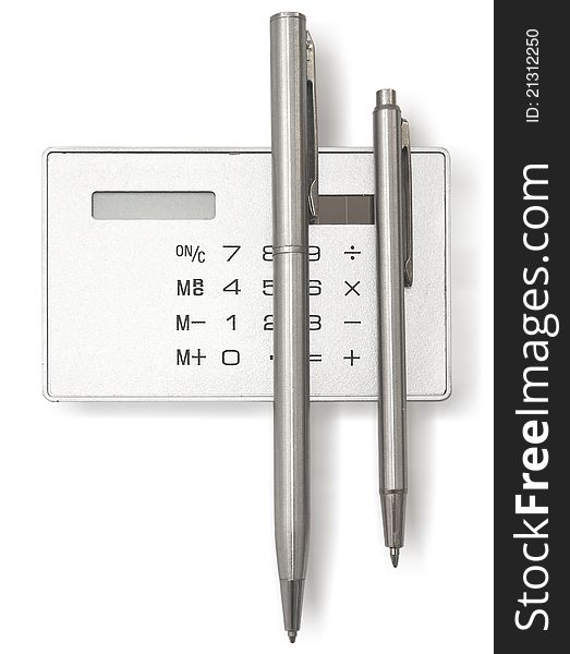 Two metal ball pens and calculator on a white background. Two metal ball pens and calculator on a white background
