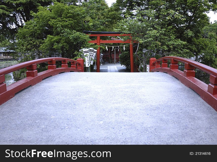 Way over Japanese bridge leads to temple's gate. Way over Japanese bridge leads to temple's gate