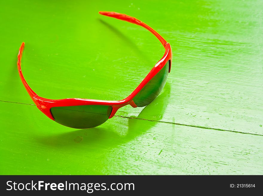 Red sunglasses on green table