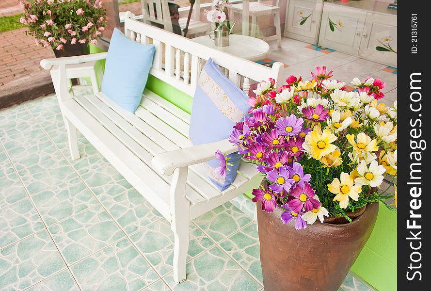 White armchair setting with flowerpot at balcony. White armchair setting with flowerpot at balcony