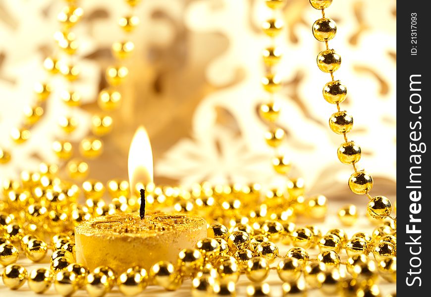 Christmas decoration, gold holiday background with candle & snowflake.