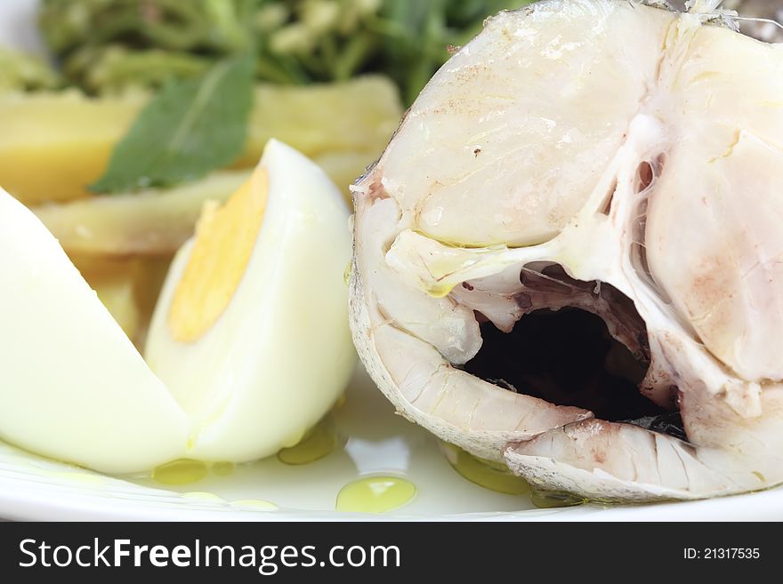 Fresh boiled fish - whiting with sweet potato and cabbage in a plate