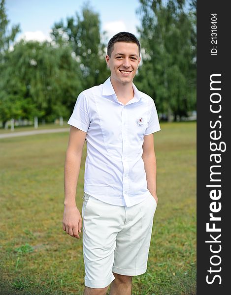 Portait of a handsome young man standing with his hands in pocket