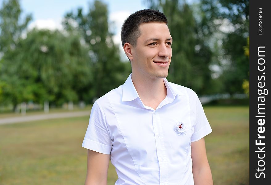 Portait of a handsome young man standing with his hands in pocket