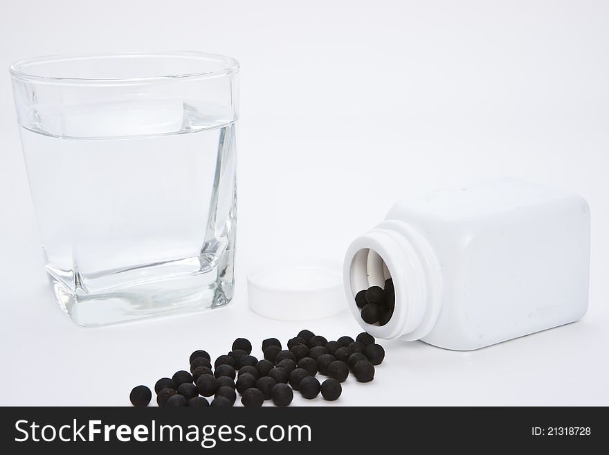 Herbal medicine pill with a glass water. Herbal medicine pill with a glass water