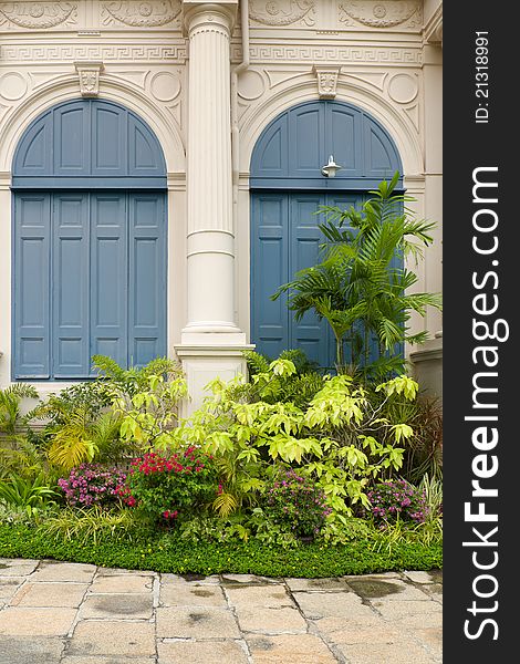 Garden in front of the building and blue wood window