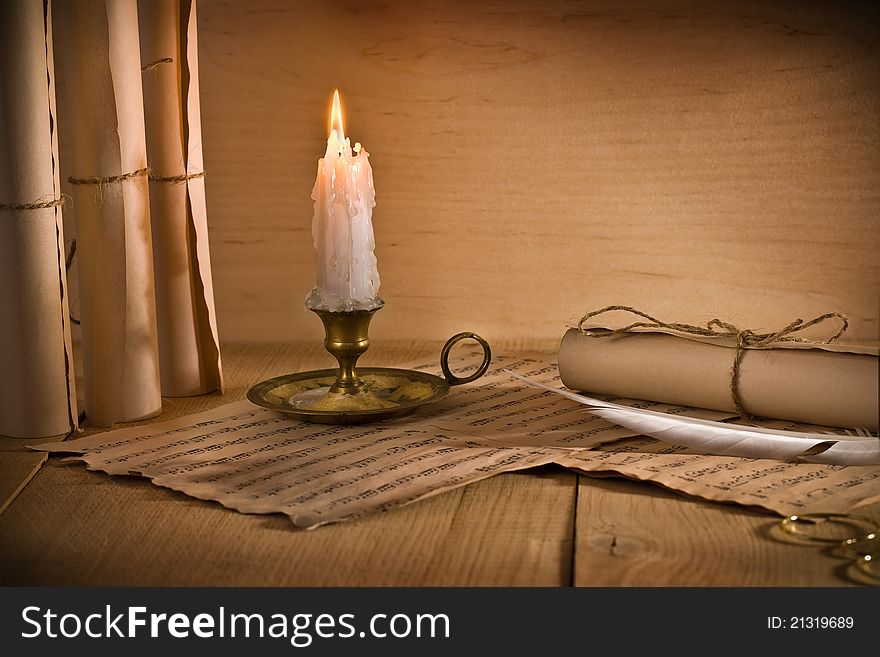 Studio shot
musical notes and burning candle on old table. Studio shot
musical notes and burning candle on old table