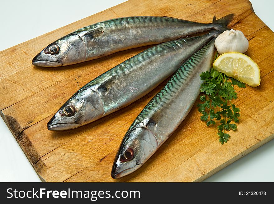 Mackerel fish isolated on wooden board