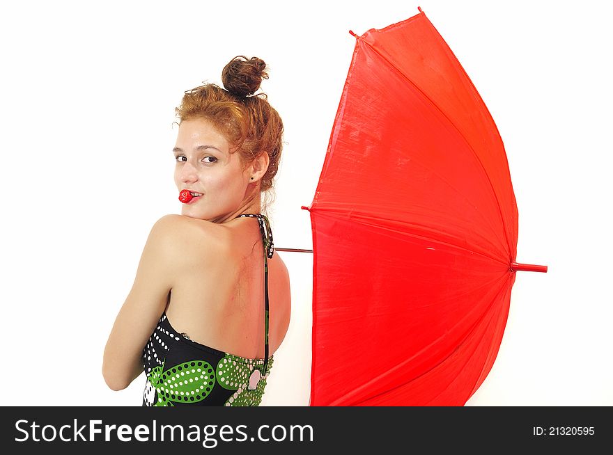 Portrait of young fresh beauty biting strawberry and holding red umbrella, isolated. Portrait of young fresh beauty biting strawberry and holding red umbrella, isolated