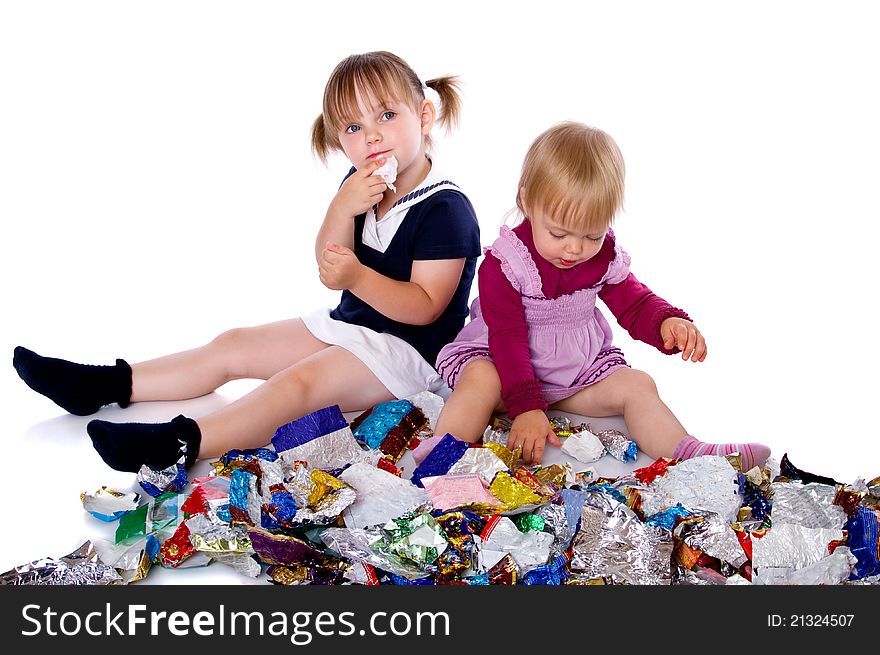Two little girls in candy wrappers from sweets