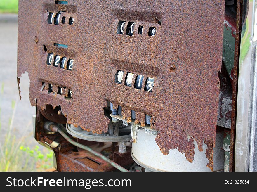 Rusty old gas pump at abandoned gas station.