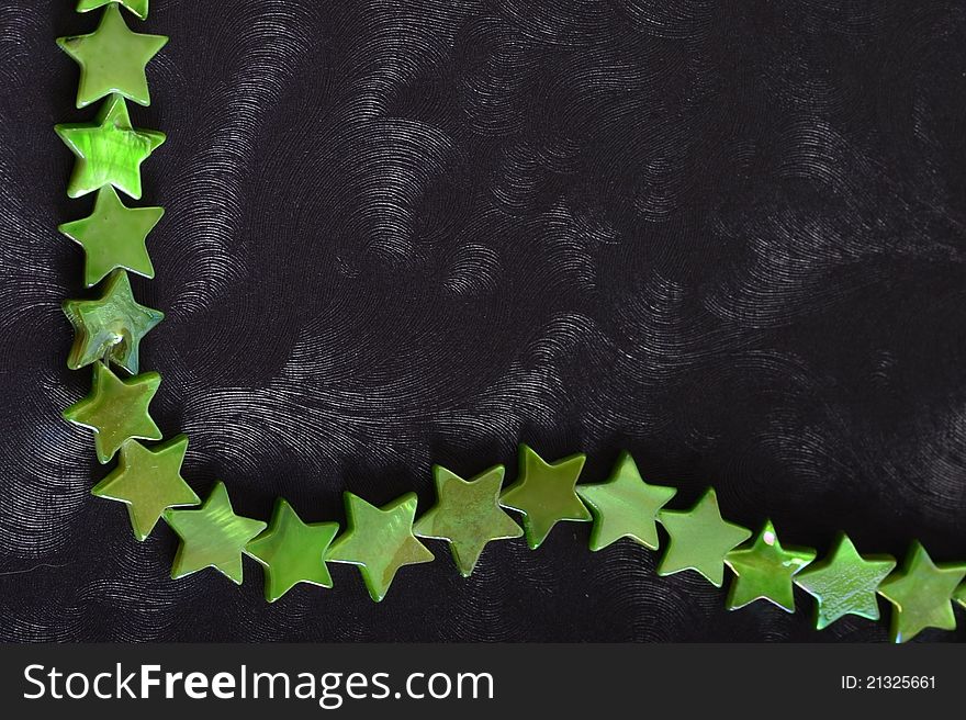 Black background with a border of green stars. Black background with a border of green stars