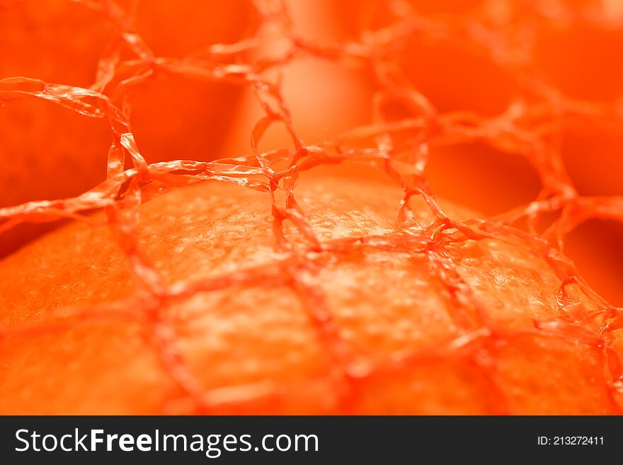 Super intense close up of a tangerine in a net