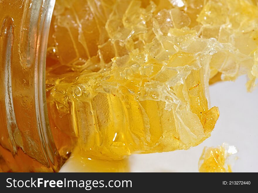 Close Up Of Fresh Honey From A Honey Comb In A Jar